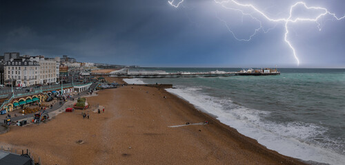 Beautiful Brighton beach view of stormy weather with thunderstorm and lightening in Brighton, UK. Town by the ocean in England.