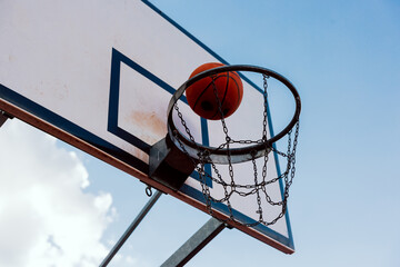 Scoring winning points at basketball game ball flies through basket.