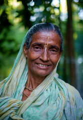 Portrait of south asian hindu religious poor elderly woman in traditional dress in outdoor 