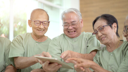 Group of Asian elder old people enjoy talking together in the living room in nursing home.