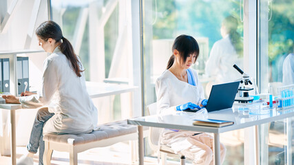 Female scientists working on their computers In modern medical research laboratory