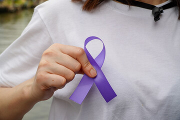 woman wearing a white dress holds a purple ribbon to save people,Pancreatic Cancer, world...
