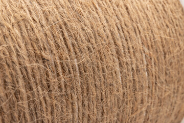 close-up of brown jute twine for DIY and gift wrapping, isolated on white background, concept of zero waste or sustainable lifestyle.