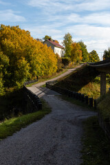 Fototapeta premium Halikko Old Bridge, built in 1866. Historic museum bridge in Salo, Finland with trees in autumn colors