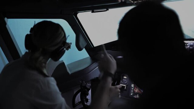 One pilot points to something interesting in the sky in the cockpit