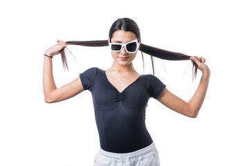 Studio portrait of young brunette model woman wearing funny fancy white sun glasses smiling