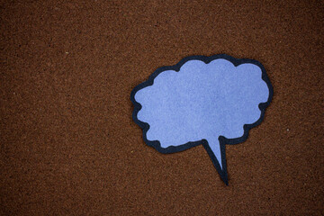 Paper speech bubble on brown background