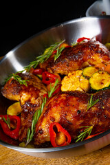 Fried chicken legs with various vegetables and spices