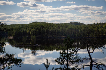 Finnish lake view landscape in summer with the reflection on lake and clouds in the sky. Repovesi National Park in Kouvola