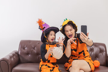 Happy Mother and daughter in witch costumes selfie themself to celebrate Halloween.