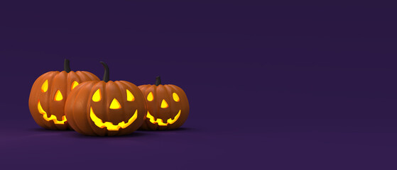 Halloween pumpkins on purple background with copy space. Jack O’ Lantern pumpkins. Happy halloween holiday concept.