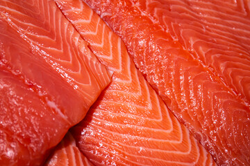 Raw salmon, trout close-up on the showcase of a seafood store.