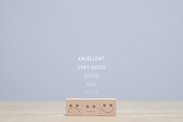 Wooden blocks with the happy face smile face symbol symbol on the table, evaluation, Increase...
