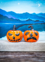 Cute little halloween pumpkin with blurred mountain background, Halloween decoration item, halloween background