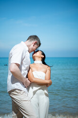 Interracial couple with the joy of traveling to the beautiful blue sea like the paradise