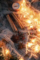 Christmas background with spices, garlands on a knitted background.