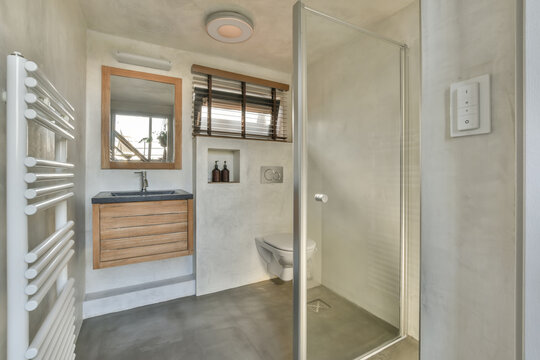 Bathroom with sink on cabinet and mirror heated towel rails