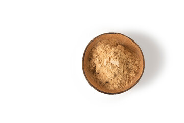 Top view of maca root powder in a bowl isolated on white