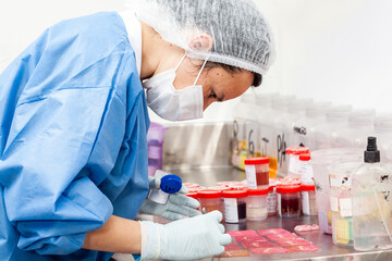 Scientist processing biopsy samples at the pathology laboratory to be embedded in paraffin for...