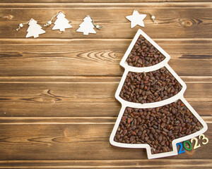 Happy New Year 2023. Christmas pine nuts in saucers in the form of a Christmas tree. Christmas...
