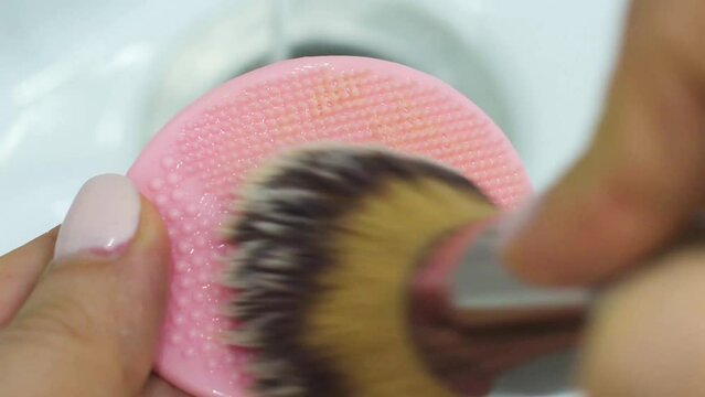 Cleaning The Brush After Makeup On A Silicone Sponge