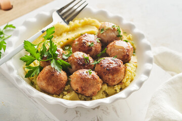 Swedish meatballs in cream sauce, potatoes and lingonberry sauce in bowl on slate, stone or concrete backgrounds. Swedish cuisine. Delicious creamy mashed potatoes. Top view.