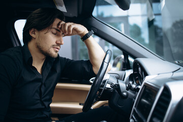 Business man tired sitting in car
