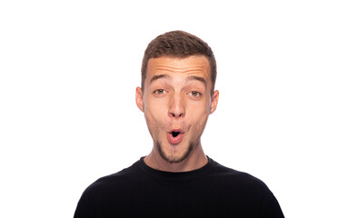 Fototapeta premium Surprised young man on a white background. The guy with his mouth open in surprise.