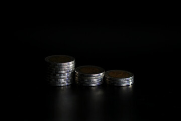 Stack of coins on black background, Saving money concept