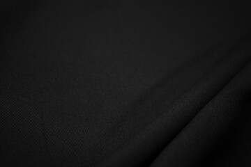 Texture of dark black fabric closeup. Low key photo. Plexus threads. Clothing industry. Abstract...