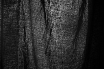 Black fabric on light. Fabric texture. Black background.