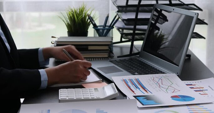 Businesswoman working at office with documents on his desk, doing planning analyzing the financial report, business plan investment, finance analysis concept	