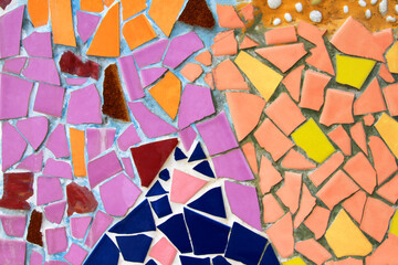 Colorful of mosaic tile floor for background. Art design wallpaper, Cracked, Shape and Abstract. Pink, red ,orange, brown, blue, yellow and purple or violet tile fragments on wall.
