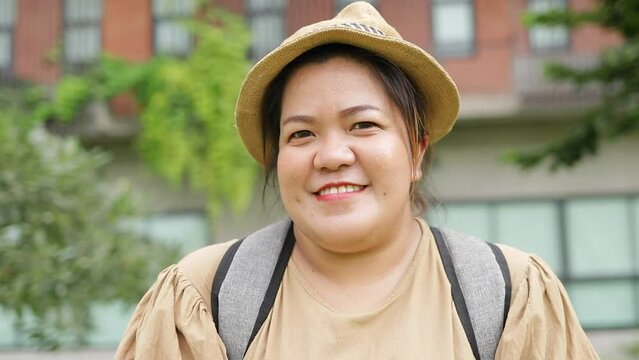 Asian fat woman traveling alone Happy with life. Fat woman looks at the camera and smiles. travel concept