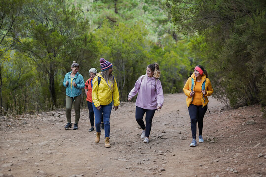 Multi Generational Women Having Fun Together During Trekking Day At Mountain Forest