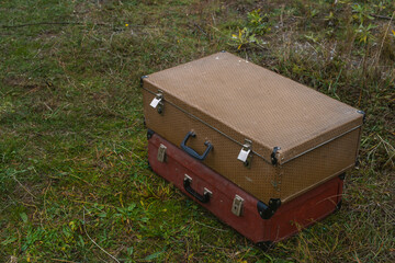 vintage suitcases on green grass meadow