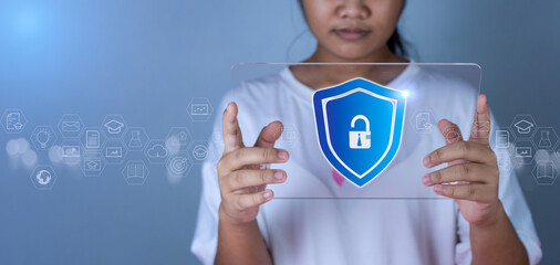 Woman holding phone tablet screen with protection icon. Represents protection against external...