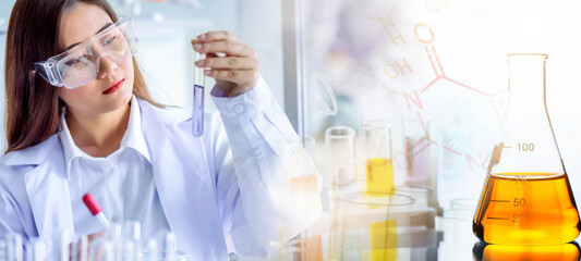 Attractive scientist woman testing chemical sample in flask at laboratory with lab glassware background. Science or chemistry research and development concept.	
