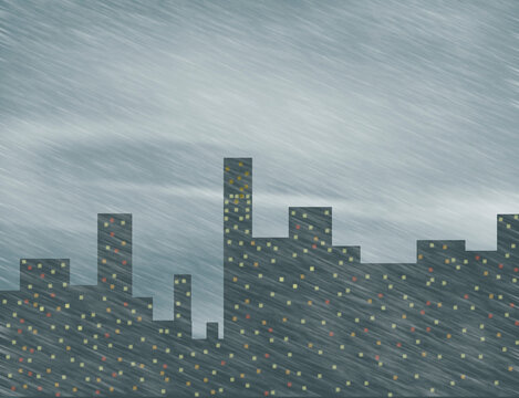 Snowstorm on the background of dark gray buildings of the city
