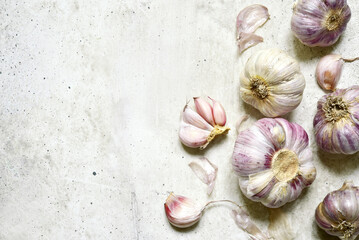 Culinary background with bulbs of garlic. Top view with copy space.