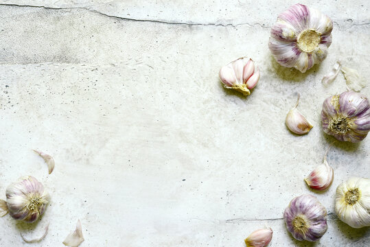 Culinary background with bulbs of garlic. Top view with copy space.