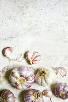 Culinary background with bulbs of garlic. Top view with copy space.