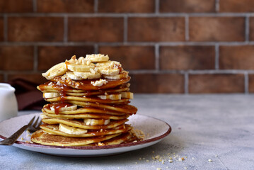 Hot pancakes with banana, nuts  and caramel sauce.