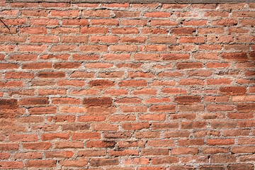 Naklejka premium abstract orange square brick block on cement wall textured and background. strong interiors house building image