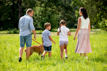 Happy family together on walk back view