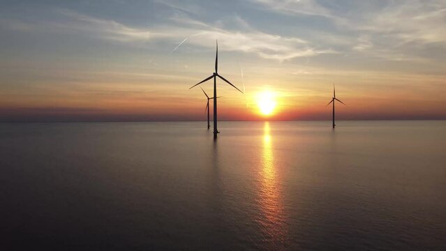 Aerial video of wind turbines in the sea during sunset in IJsselmeer near Urk in Flevoland, The Netherlands