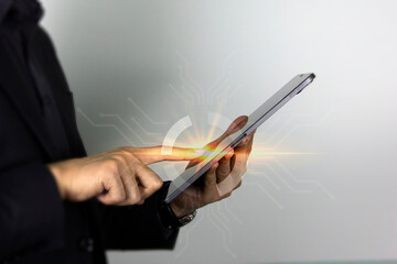 Smart man's finger pointing on a touch screen technology device, and a business man touching on iPad screen