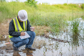 Environmental engineers inspect water quality,Bring water to the lab for testing,Check the mineral content in water and soil,Check for contaminants in water sources. - obrazy, fototapety, plakaty