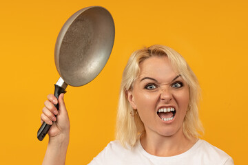 an angry woman with an animal grin brandishes a frying pan. last straw concept