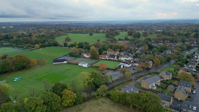 Aerial footage flying over Adel, Leeds, towards sports ground